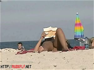 torrid babes filmed lounging on a naturist beach